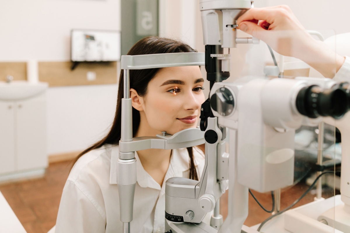 Optometrist checking a patient’s eye health using a slit lamp microscope during a routine exam.